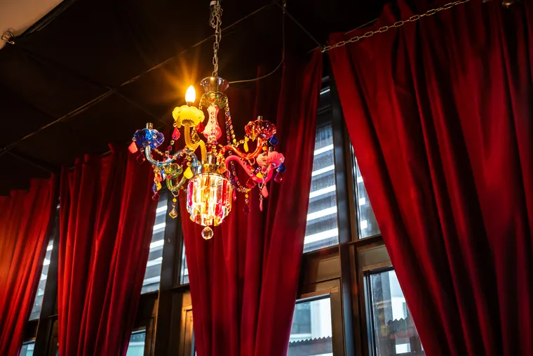 Red curtain and chandelier at die kunstbar
